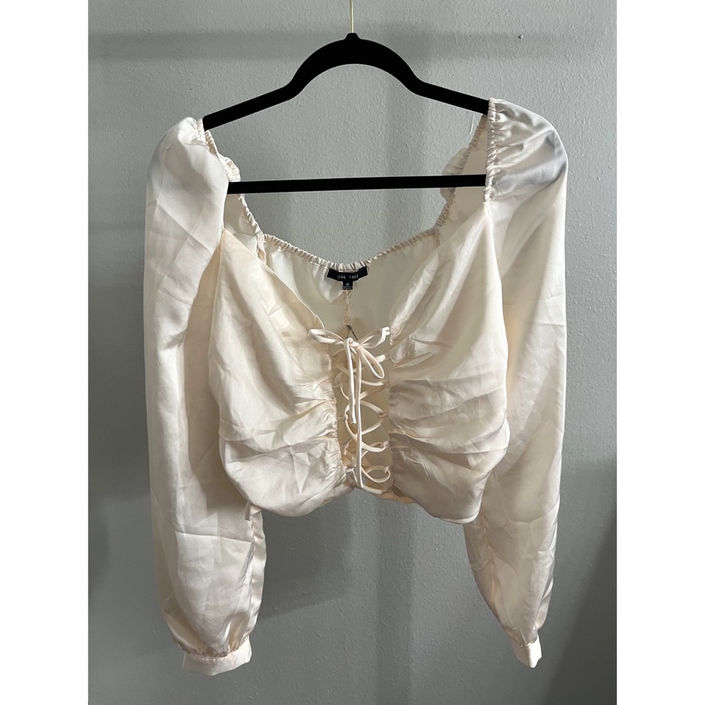 medium, off white top, tag on it
